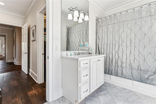 bathroom with crown molding, vanity, shower / bath combo, and hardwood / wood-style flooring