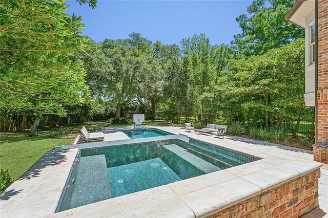 view of swimming pool featuring an in ground hot tub and a patio area