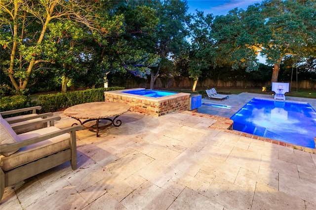 view of swimming pool featuring an in ground hot tub and a patio area