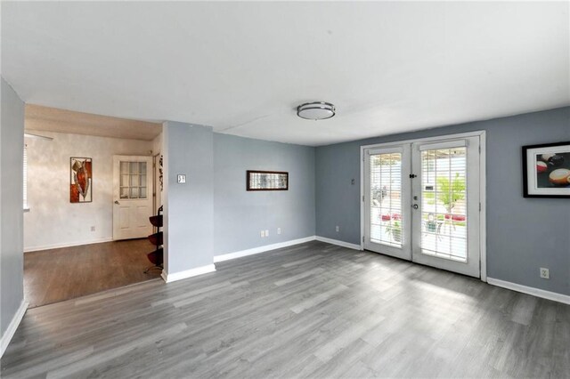 empty room featuring french doors and hardwood / wood-style floors