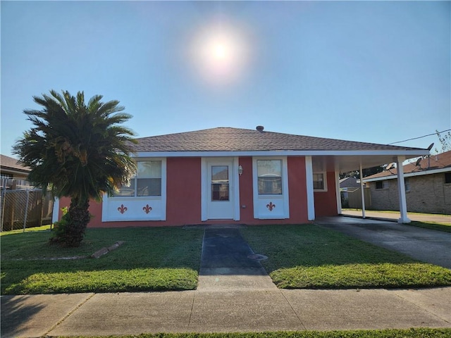 ranch-style home with a front yard and a carport