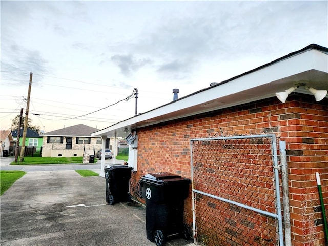 ranch-style home featuring a carport and a yard