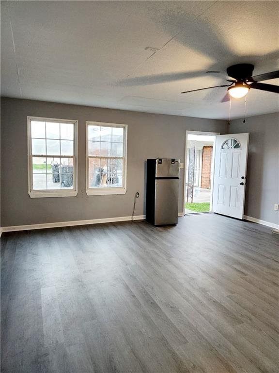 spare room with ceiling fan and dark hardwood / wood-style floors