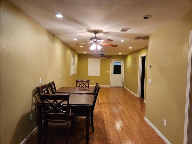 dining area featuring light wood-type flooring and ceiling fan