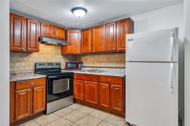 kitchen featuring stainless steel electric stove, tasteful backsplash, sink, white refrigerator, and light tile patterned floors