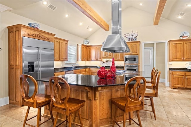 kitchen featuring island exhaust hood, built in appliances, beamed ceiling, and high vaulted ceiling