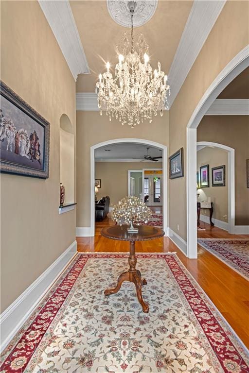 foyer featuring crown molding, ceiling fan, and hardwood / wood-style flooring