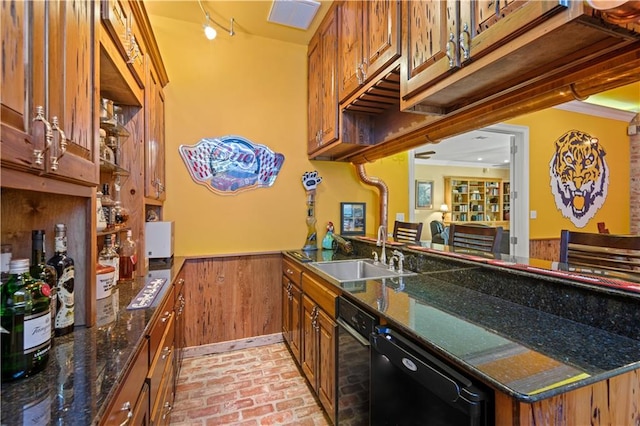 bar with dark stone countertops, ornamental molding, black dishwasher, and sink