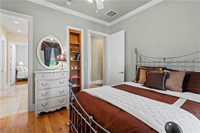 bedroom with ceiling fan, light wood-type flooring, and ornamental molding