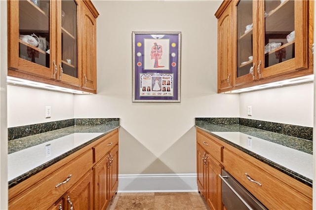 kitchen featuring dark stone countertops and light tile patterned floors