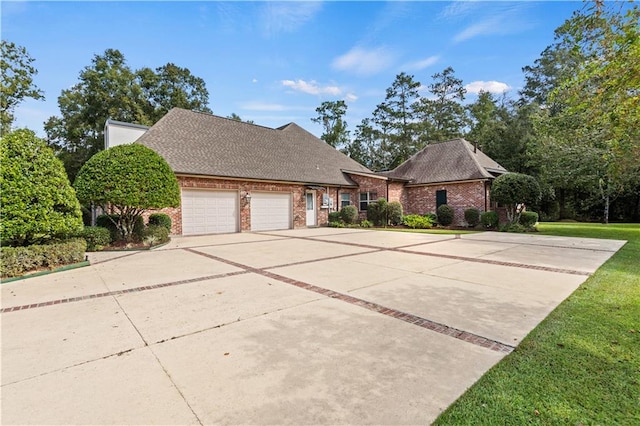 view of front of home with a front yard and a garage