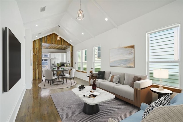 living room featuring hardwood / wood-style flooring, wood walls, and high vaulted ceiling