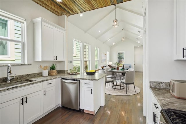 kitchen featuring white cabinets, vaulted ceiling, kitchen peninsula, and a wealth of natural light