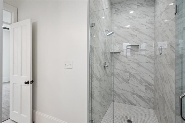 bathroom with a shower with door