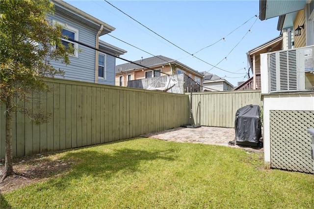 view of yard with a patio area and central air condition unit