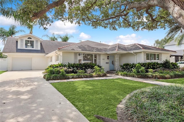 view of front of house with a front yard and a garage