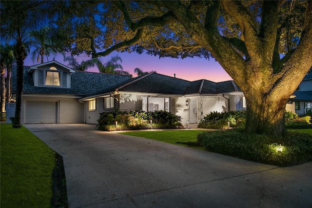 view of front facade featuring a lawn and a garage