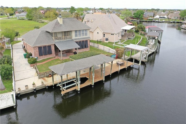 view of dock featuring a water view and a lawn