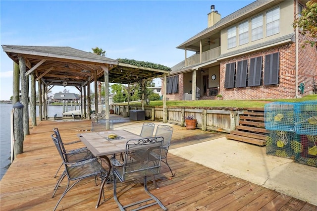 wooden terrace featuring a water view