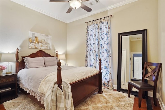 bedroom with ceiling fan, hardwood / wood-style flooring, and crown molding