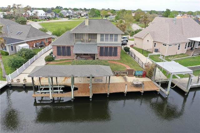 dock area featuring a yard and a water view