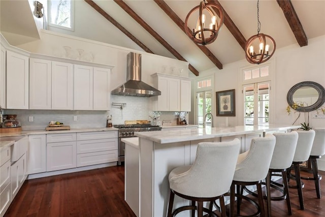 115 Holly St, Mandeville, LA 70448 - kitchen with high quality appliances, wall chimney range hood, a chandelier, and a sink