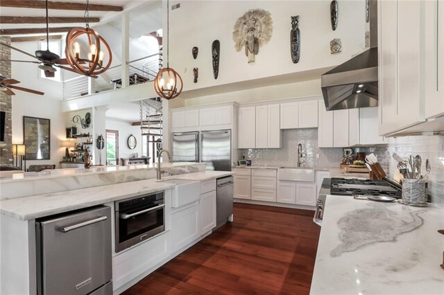 115 Holly St, Mandeville, LA 70448 - dining space with plenty of natural light, dark wood-type flooring, french doors, a chandelier, and beamed ceiling