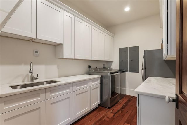 laundry room with cabinet space, dark wood-type flooring, a sink, washer hookup, and electric dryer hookup