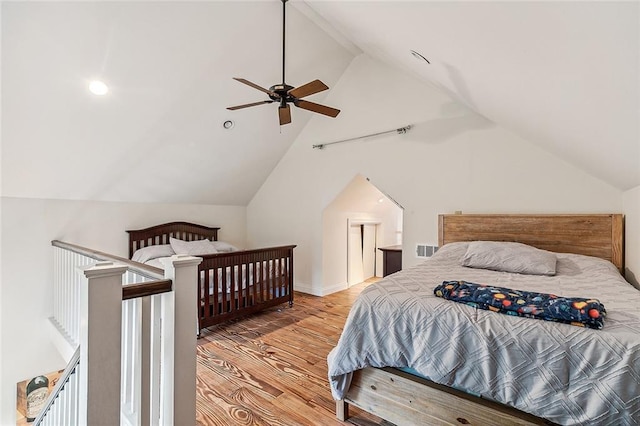 bedroom with visible vents, vaulted ceiling, light wood finished floors, and ceiling fan