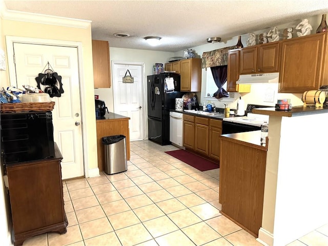 kitchen featuring a textured ceiling, crown molding, white appliances, and light tile patterned flooring