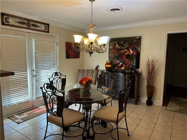 dining room with a notable chandelier, a textured ceiling, light tile patterned floors, and crown molding