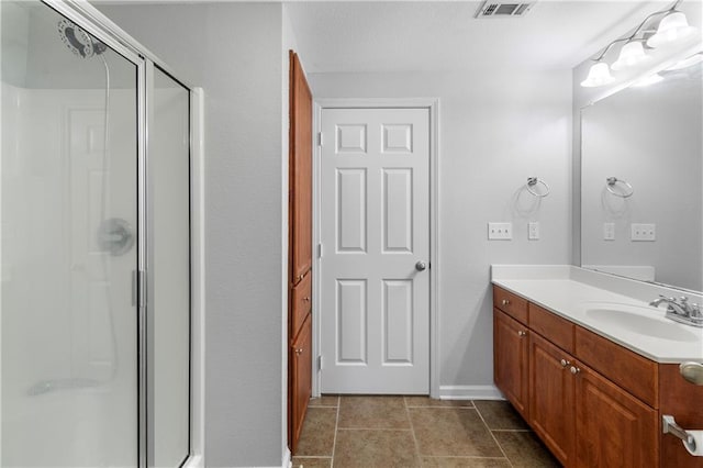 bathroom with walk in shower, tile patterned flooring, and vanity