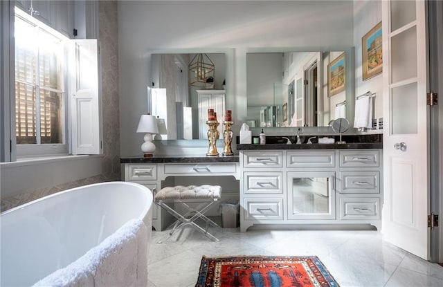 bathroom with vanity and a tub to relax in