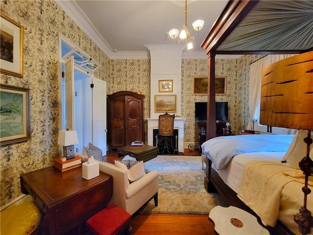 bedroom with hardwood / wood-style floors, crown molding, and a chandelier