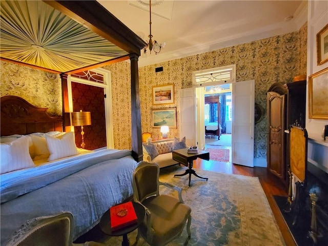 bedroom featuring a notable chandelier, dark hardwood / wood-style floors, and crown molding