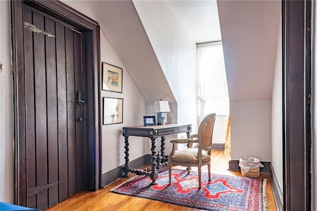 office space featuring vaulted ceiling and hardwood / wood-style flooring