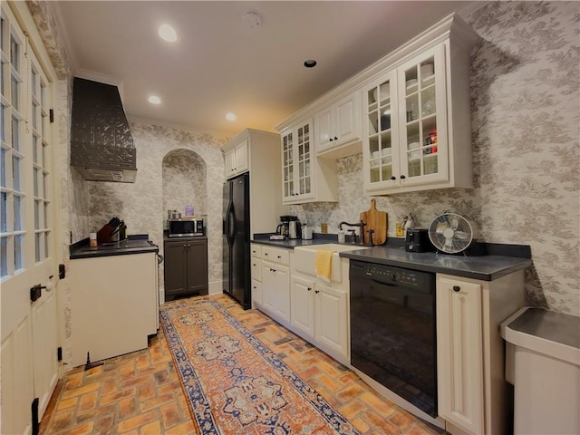 kitchen with exhaust hood, sink, white cabinets, and black appliances