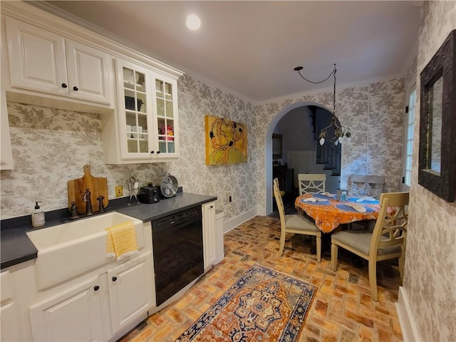 kitchen featuring dishwasher, crown molding, white cabinetry, and sink