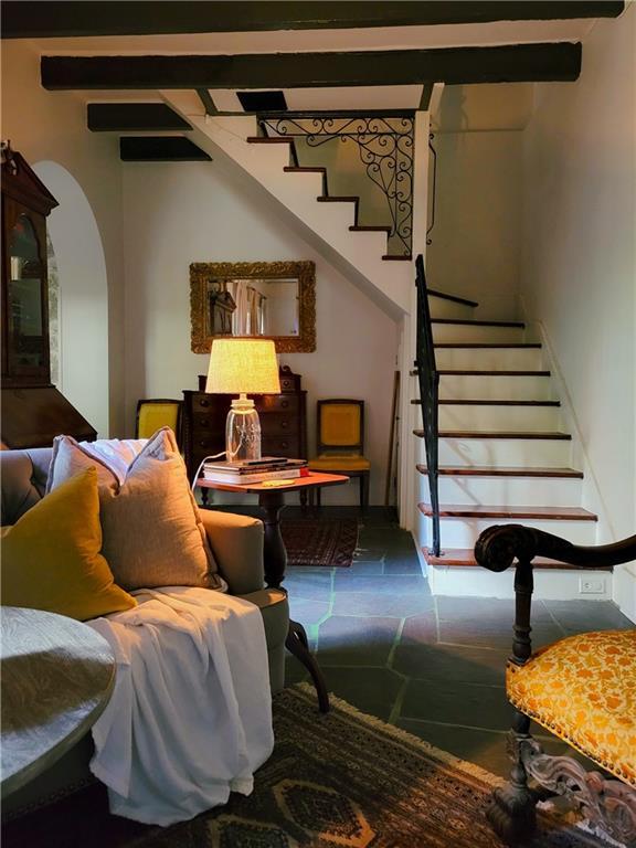 sitting room featuring beam ceiling