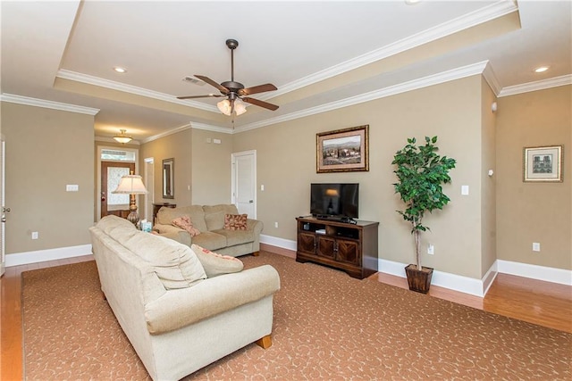 living room featuring ceiling fan, a raised ceiling, crown molding, and hardwood / wood-style floors