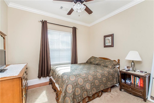 bedroom with crown molding, light carpet, and ceiling fan