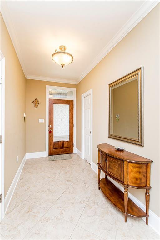 324 38th St, New Orleans, LA 70124 - foyer entrance featuring ornamental molding and baseboards