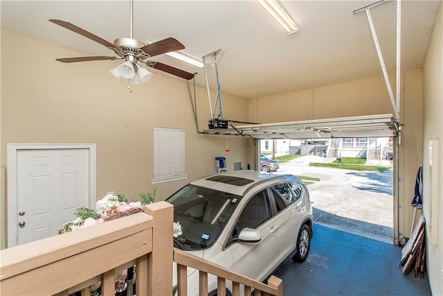 garage featuring ceiling fan, a garage door opener, and a carport