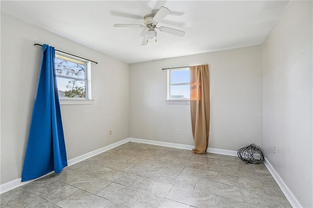 spare room with a healthy amount of sunlight and ceiling fan