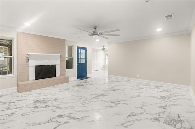 unfurnished living room featuring ceiling fan, crown molding, and a brick fireplace