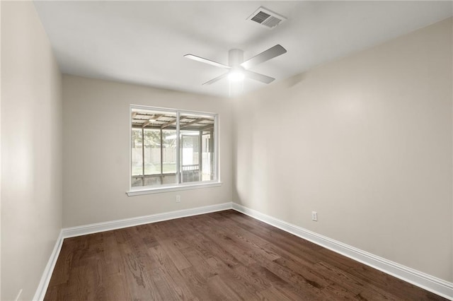 empty room with ceiling fan and dark wood-type flooring