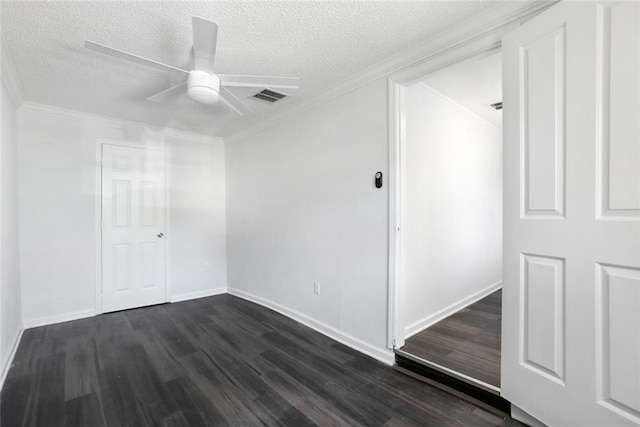 spare room with a textured ceiling, ornamental molding, ceiling fan, and dark wood-type flooring