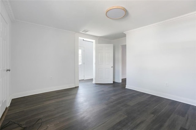 empty room with dark hardwood / wood-style floors and crown molding