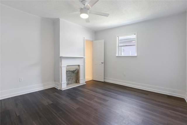 2252 N Villere St, New Orleans, LA 70117 - unfurnished living room with dark wood-style flooring, a textured ceiling, a ceiling fan, and a fireplace with raised hearth