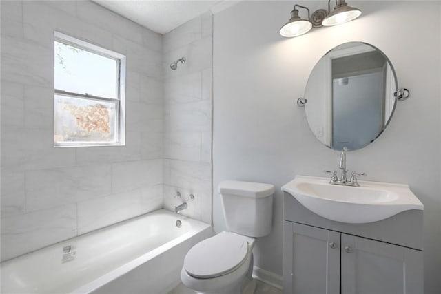 full bathroom with tiled shower / bath, vanity, and toilet